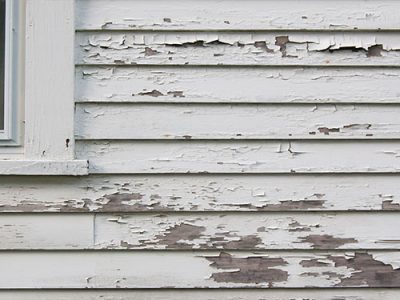 Paint peeling from wood surface due to weathering